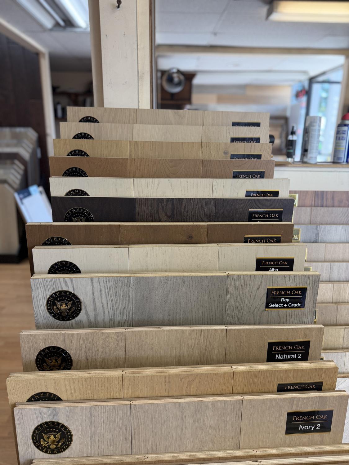 Inside the Express Carpet & Flooring showroom in Anaheim, with hardwood and vinyl displays along the aisle