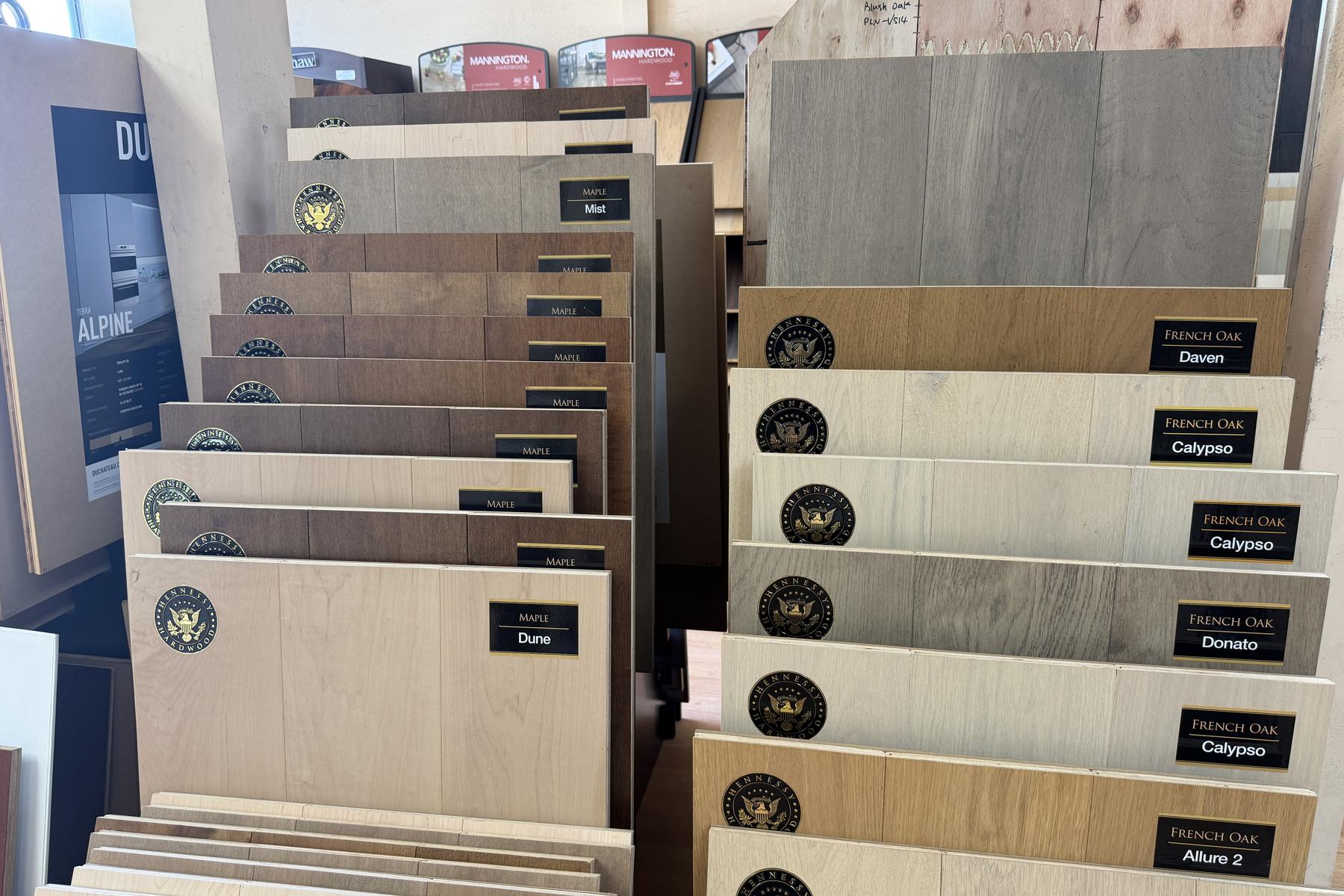 Racks of hardwood and vinyl samples filling the Express Carpet showroom floor in Anaheim