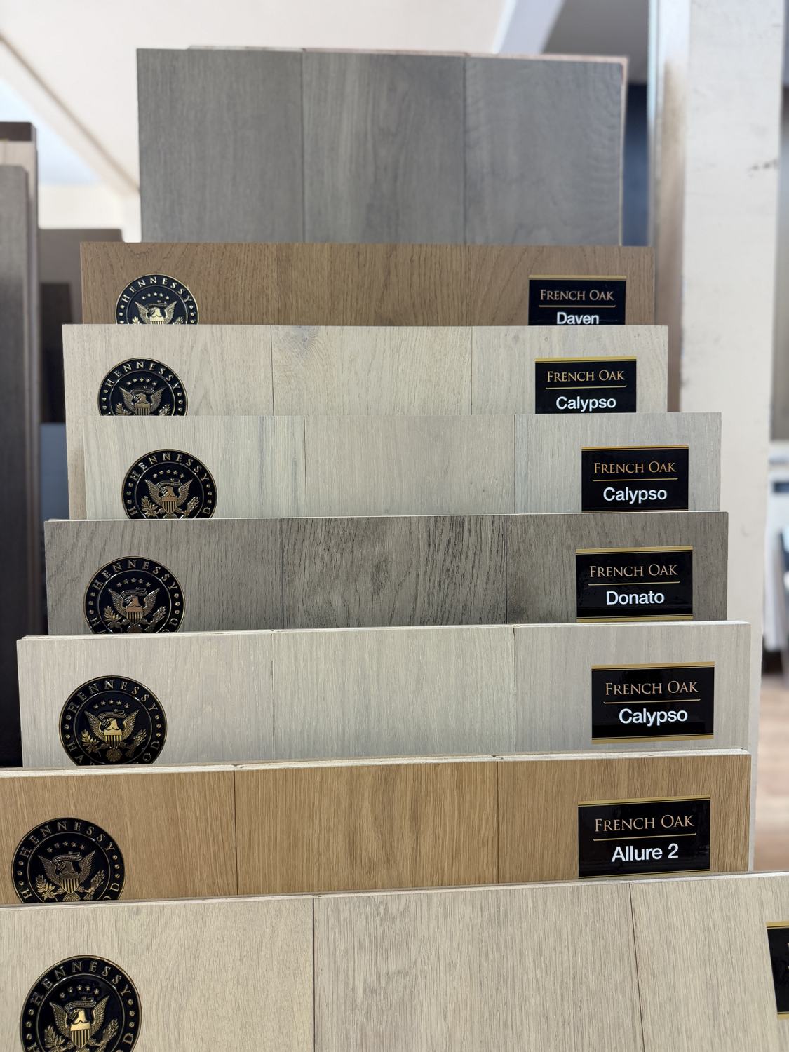 Hennessy Hardwood French Oak samples fanned out in the Anaheim showroom, labelled Daven, Calypso, Donato and Allure 2